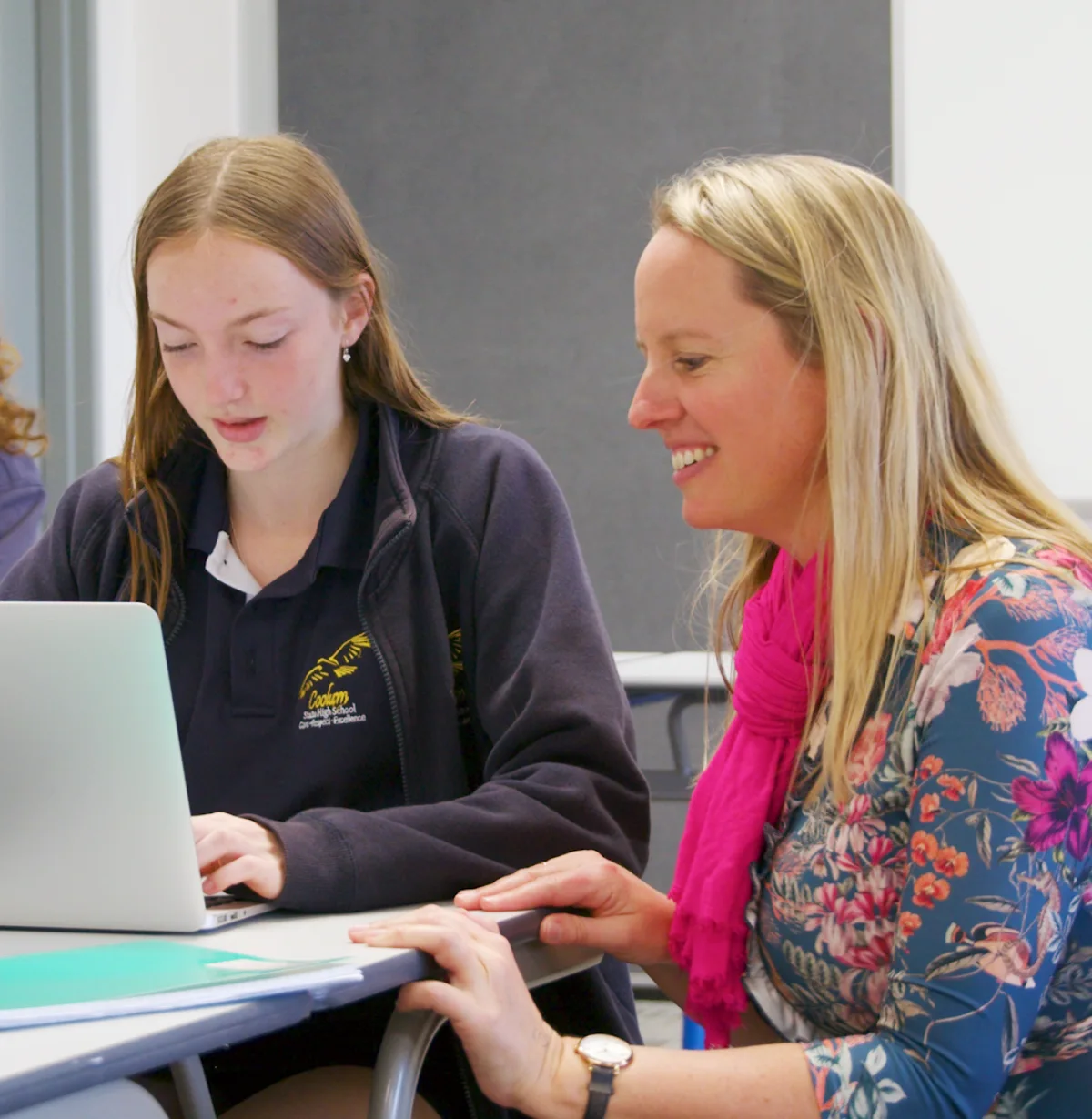 Teacher in Classroom Talking to a Student Lifting Student Agency